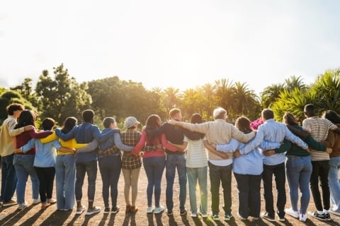 Group of people locked by arms.